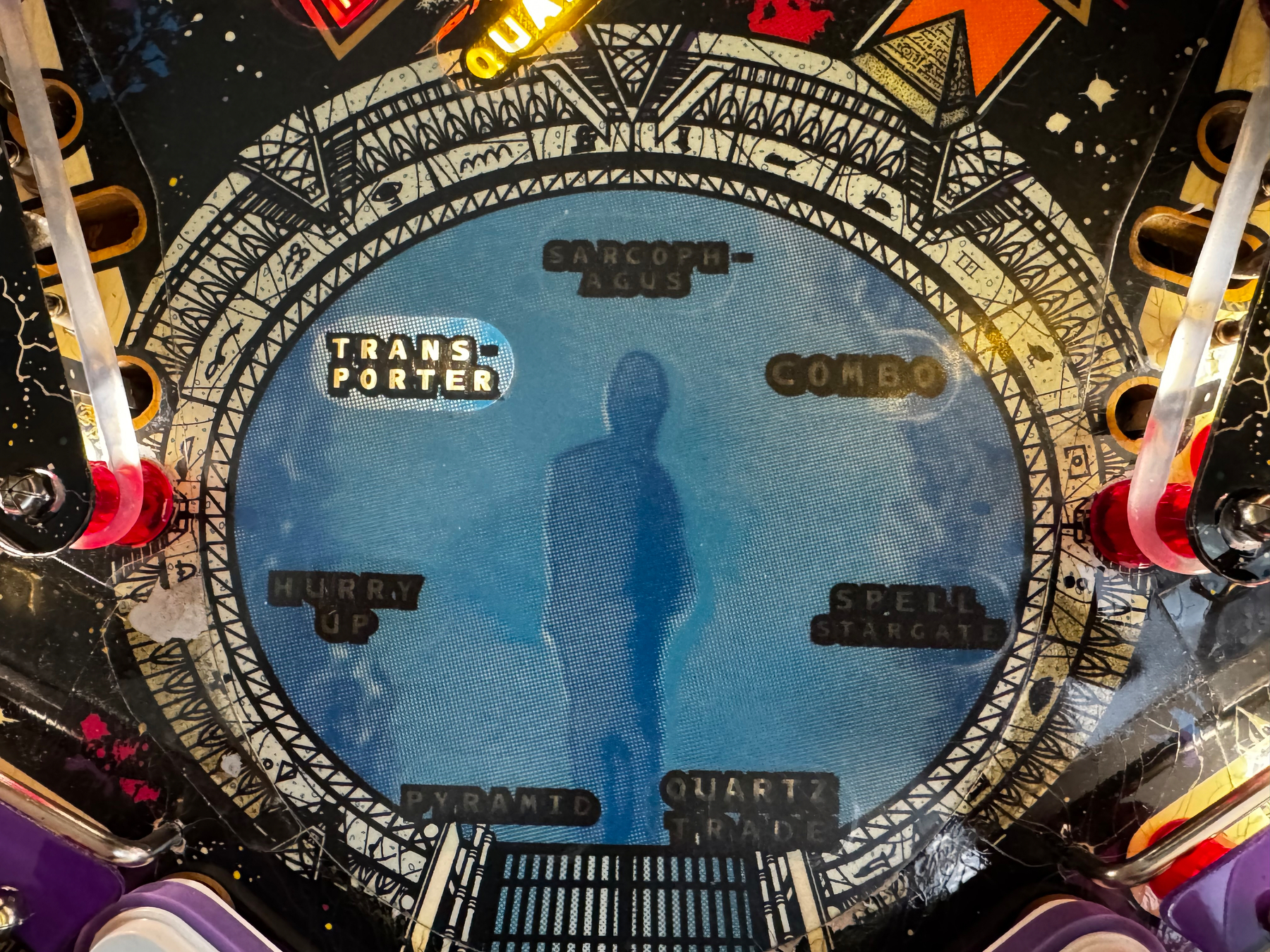 A pinball machine playfield features vibrant graphics with flaming arrows and the words COMBO, LIGHT DOUBLE, and BEGIN COMBO.