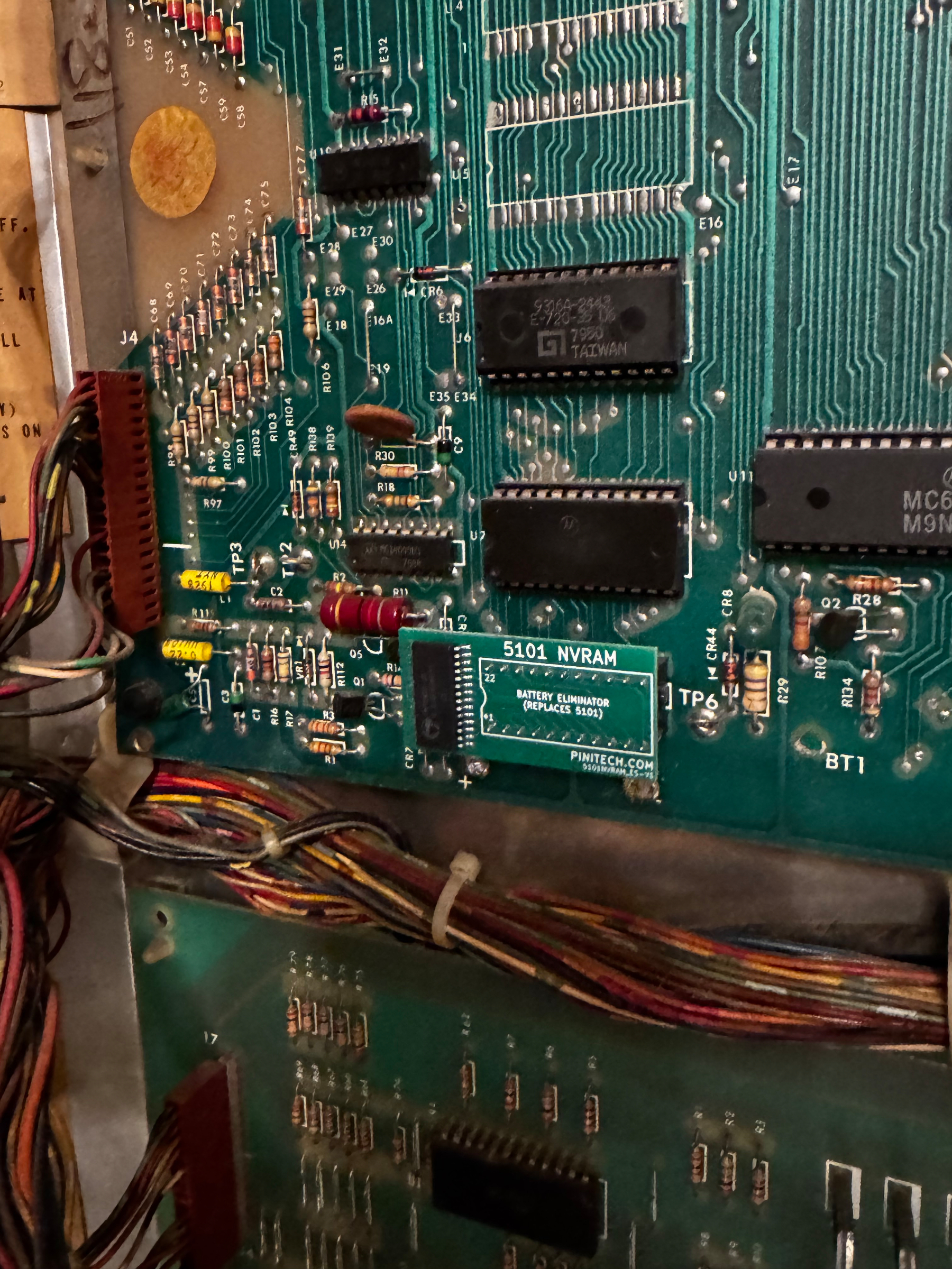 A circuit board with various electronic components and wiring is visible, featuring a 5101 NVRAM chip.