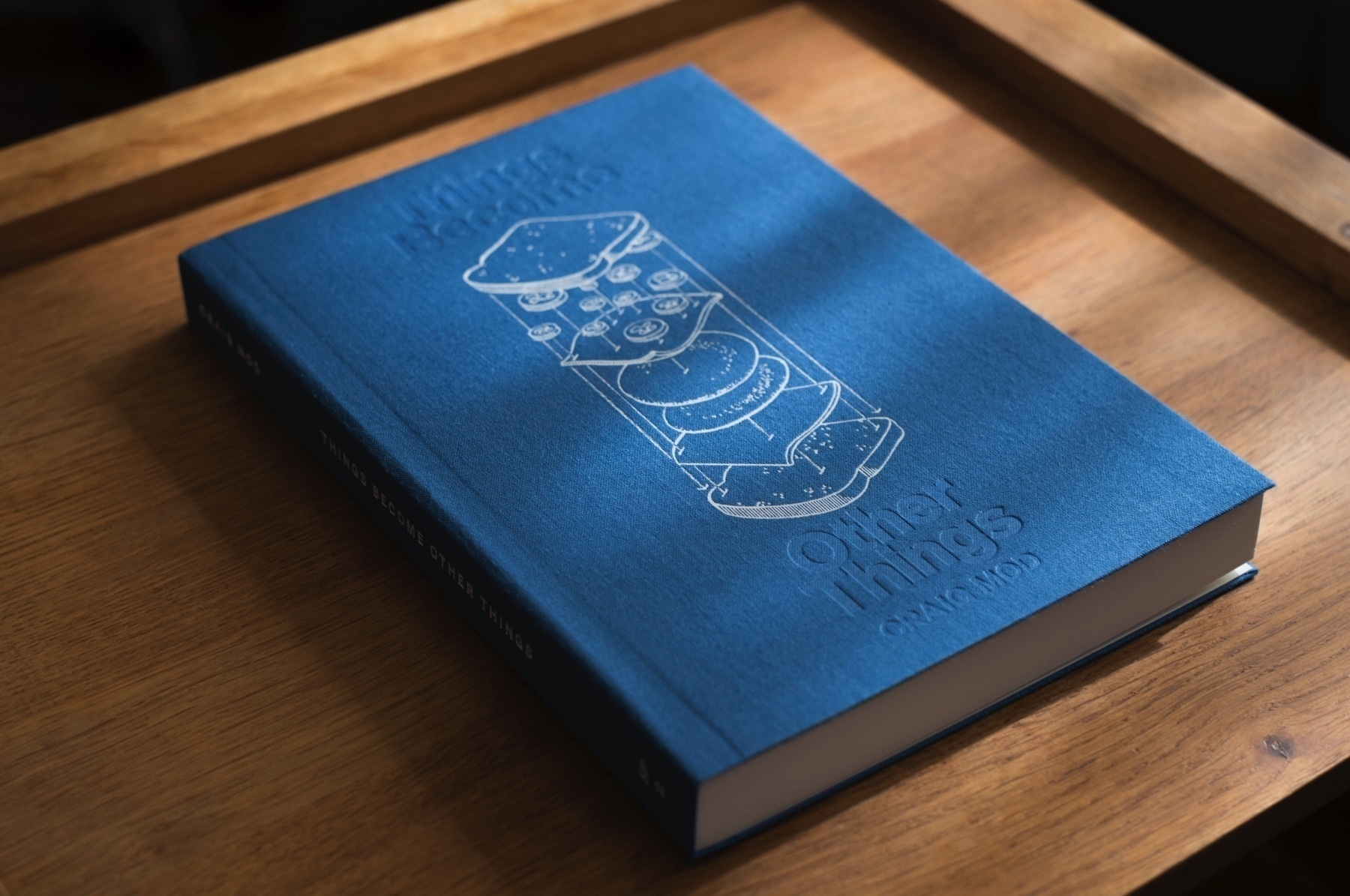 A beautiful blue book with a deconstructed sandwich on the cover
