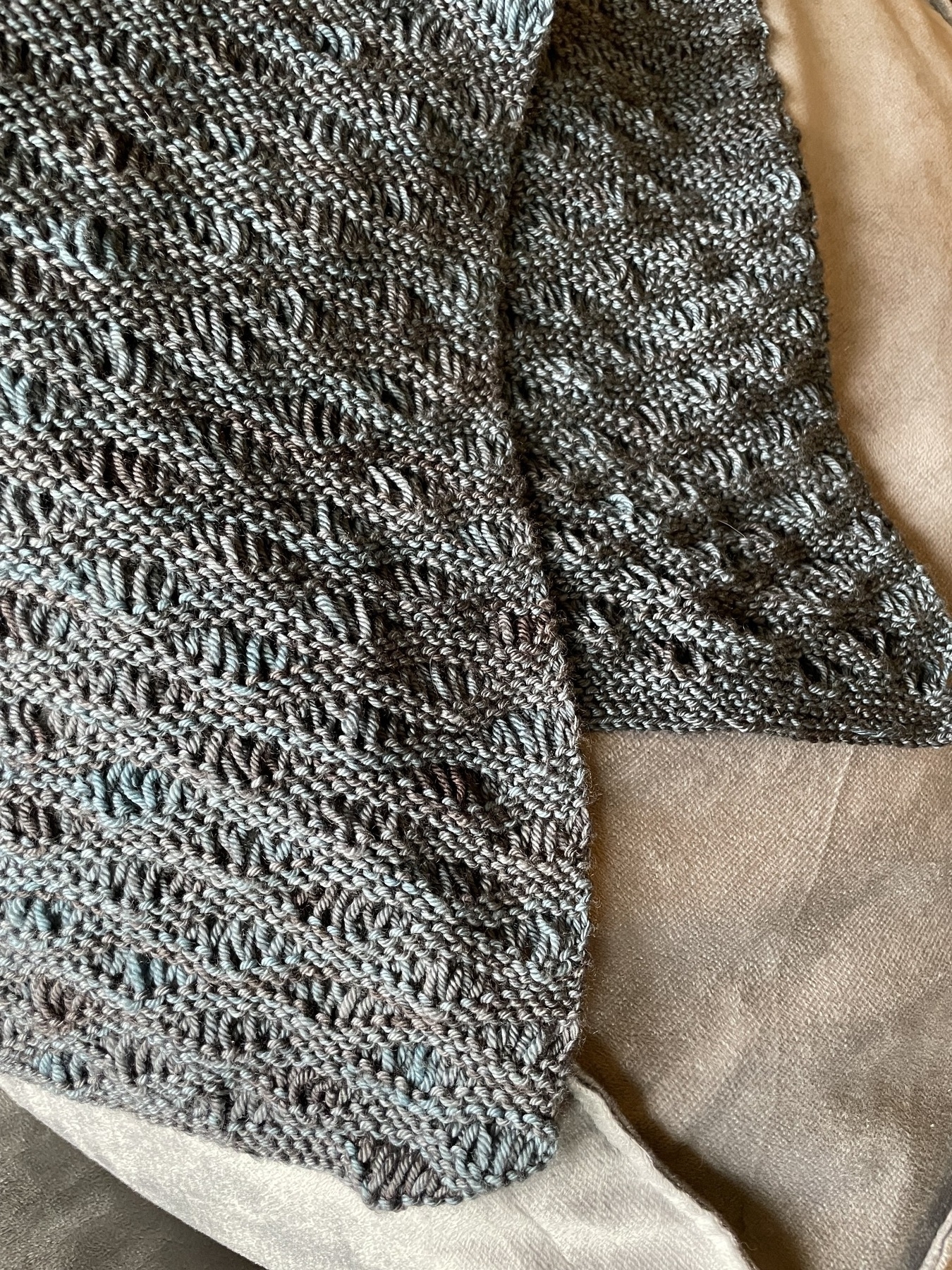 knitted scarf with a wavy drop-stitch pattern in steel blue yarn