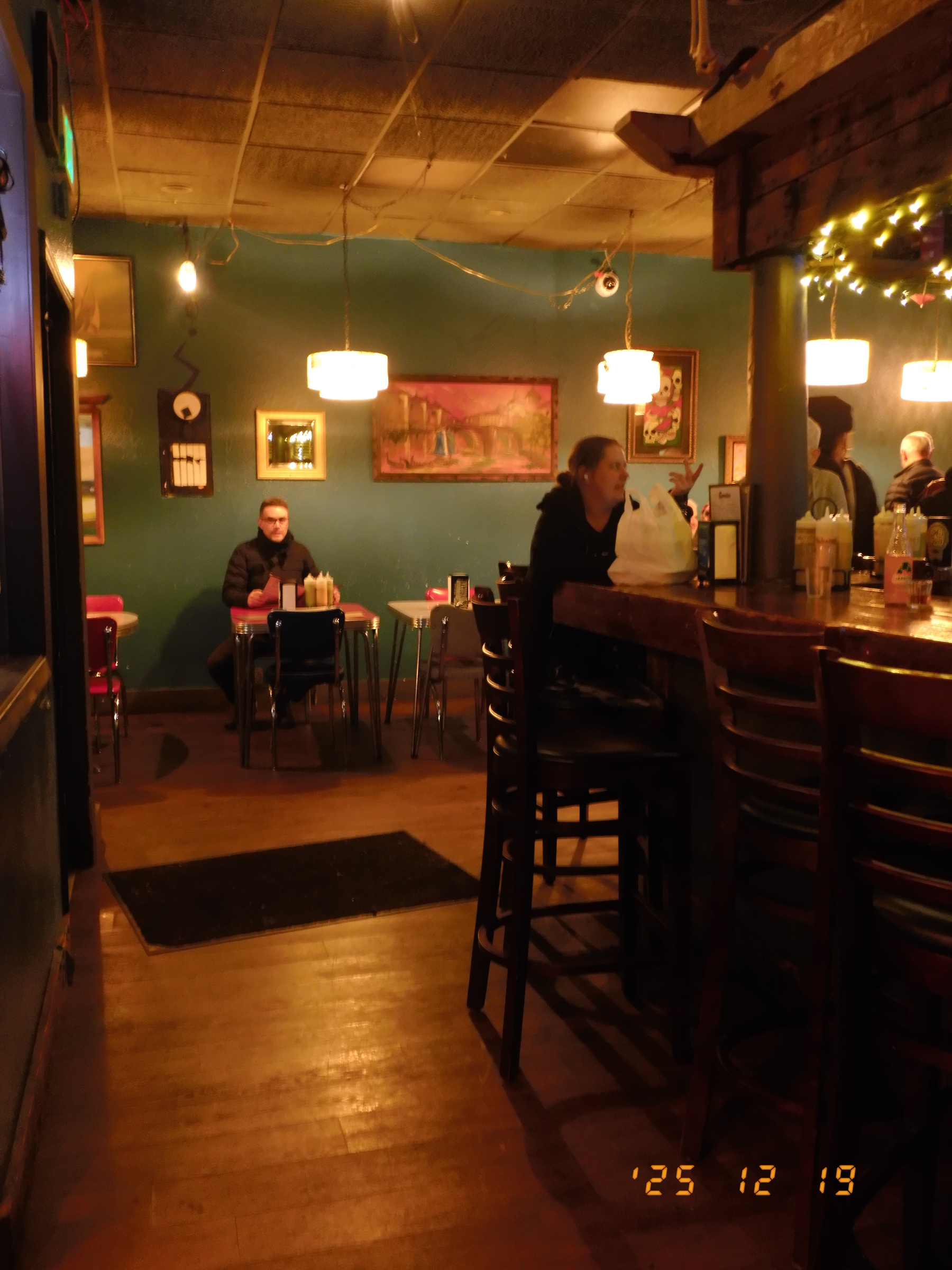 A crowd of people are enjoying a concert with bright stage lights in the background.