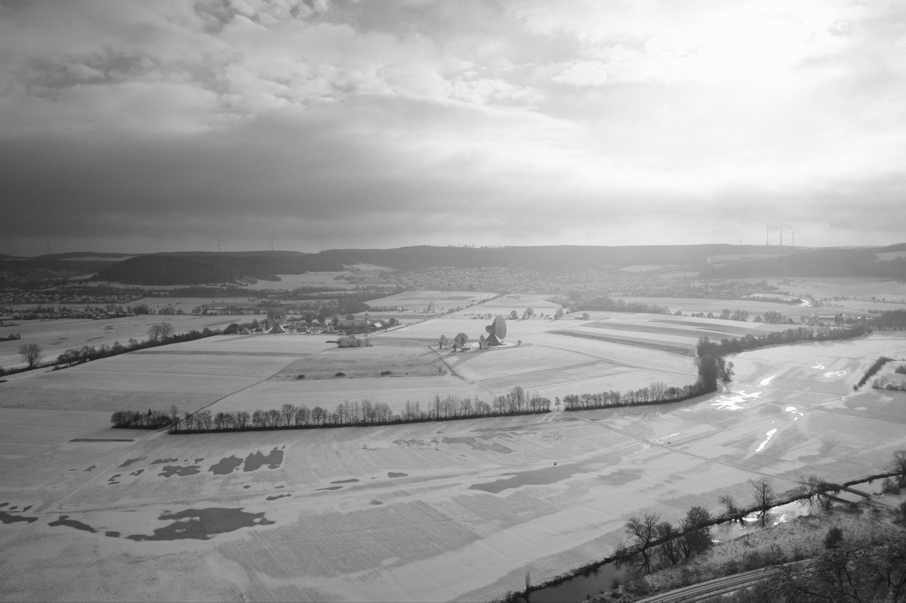 a black and white photo of the Saale valley covered in ice and snow 