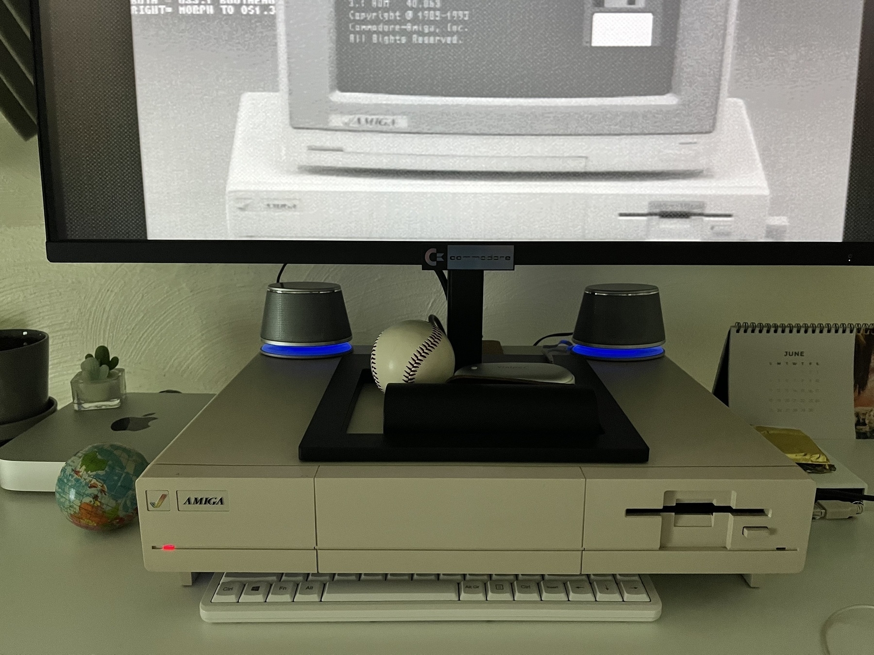 AmazonBasics computer speakers on top of Amiga 1000 with flat panel monitor