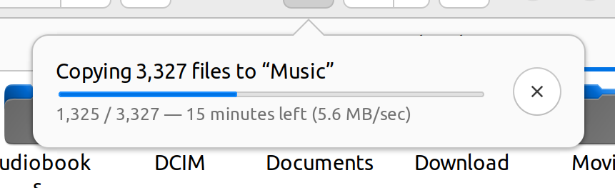 A file manager dialog showing progress on copying a large number of music files