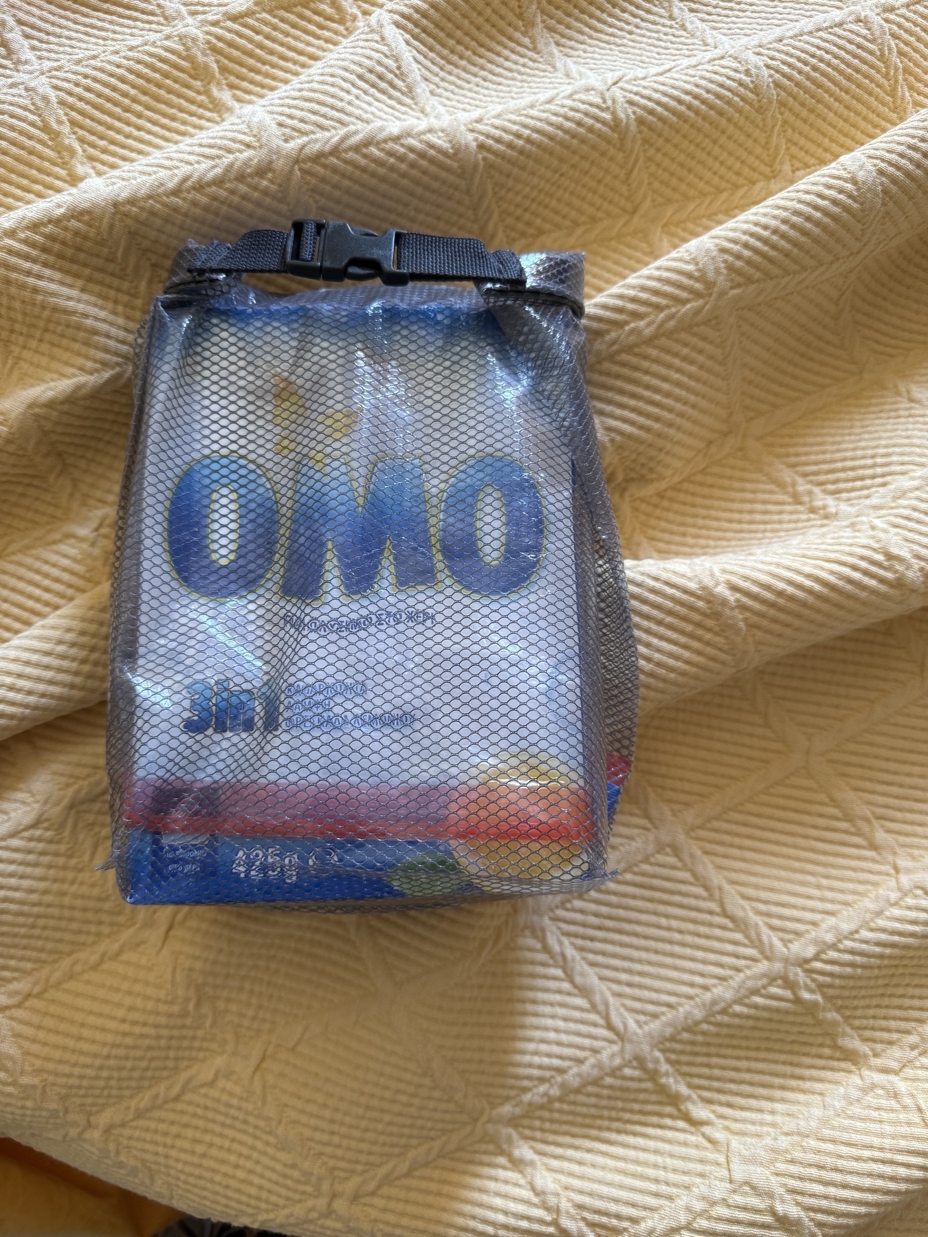 A box of "OMO" laundry detergent in a dry bag