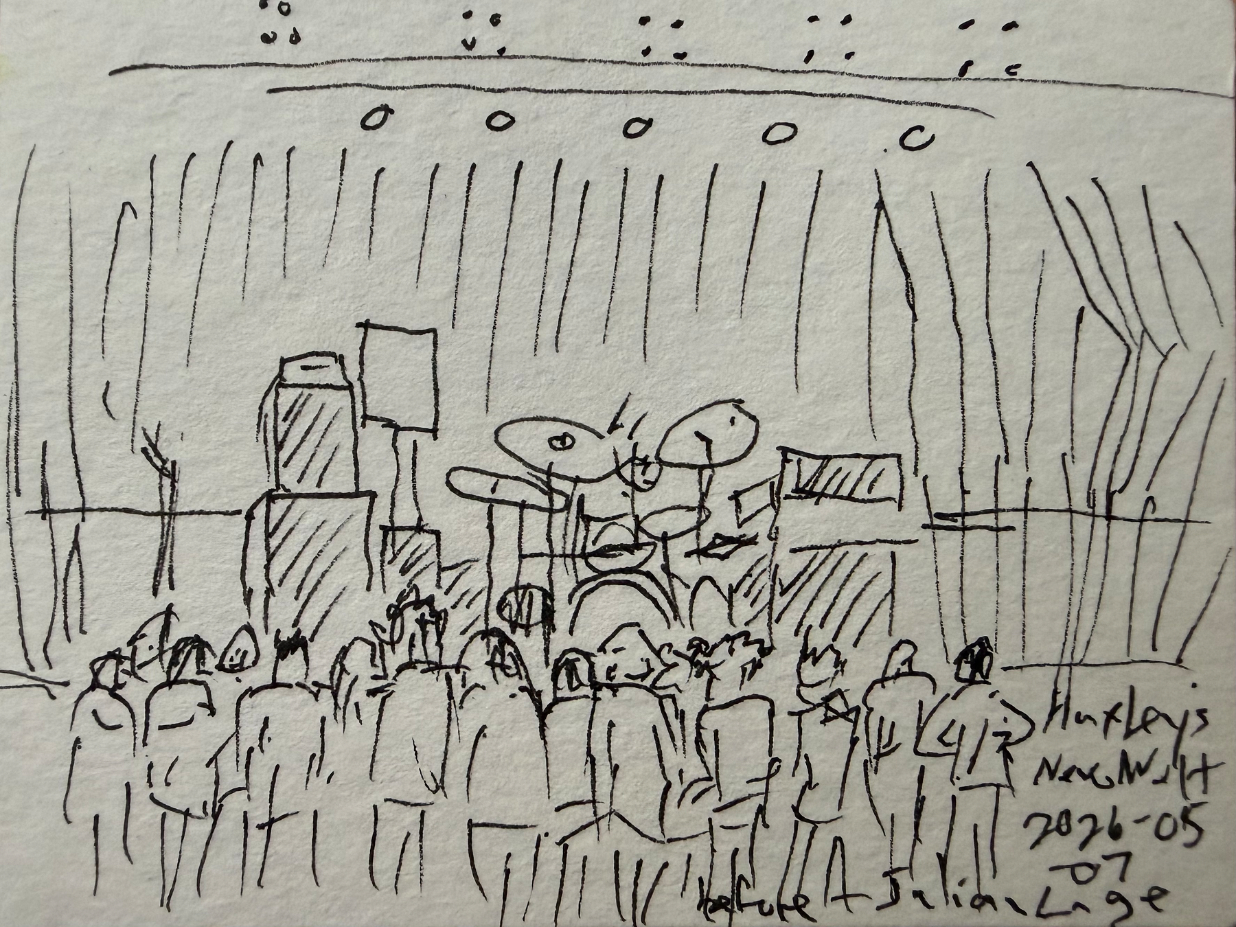A line drawing of a gathering crowd standing in front of a dark stage set with drums and amplifiers.