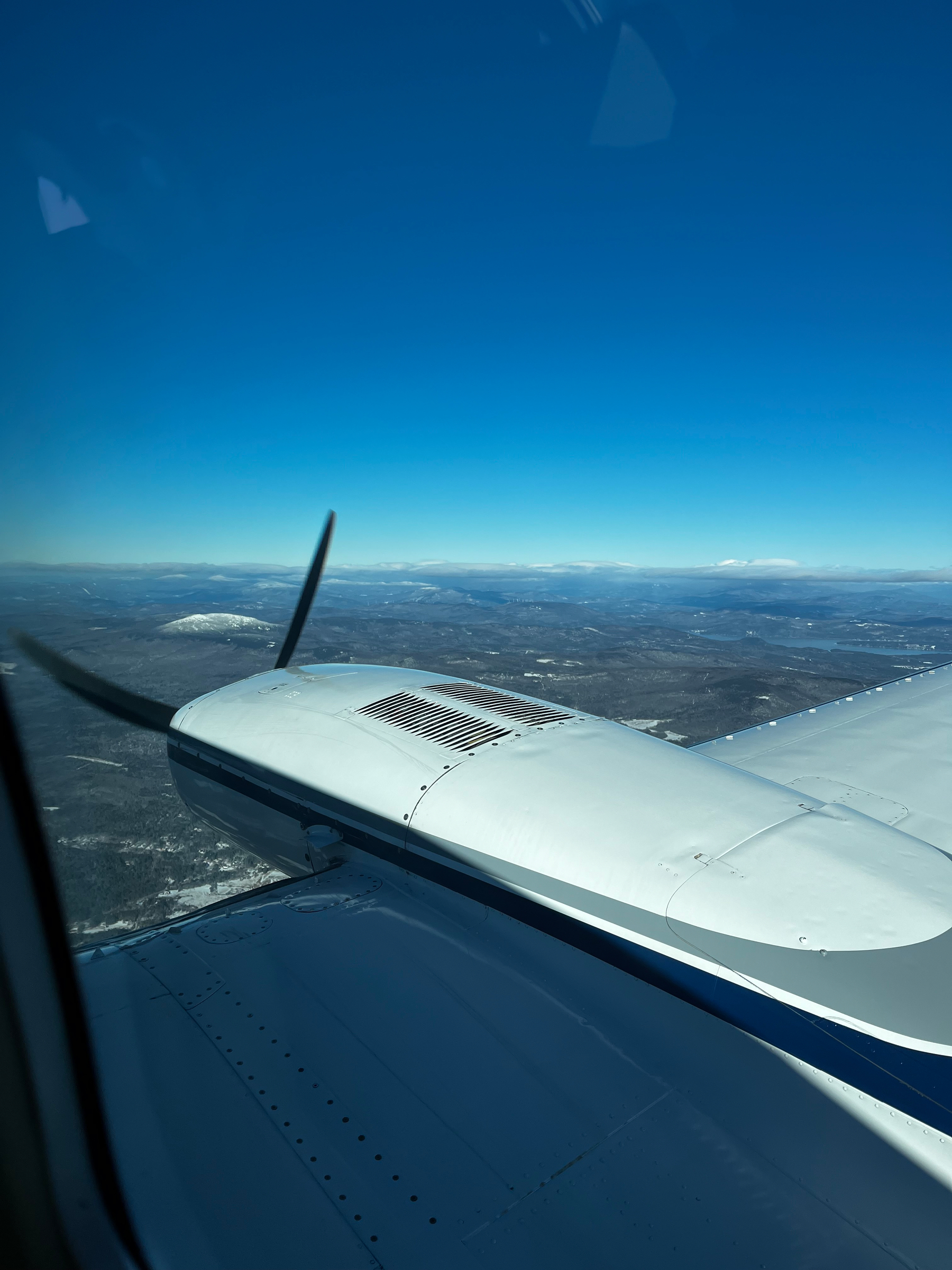 A view of a Cessna 402C wing over New Hampshire