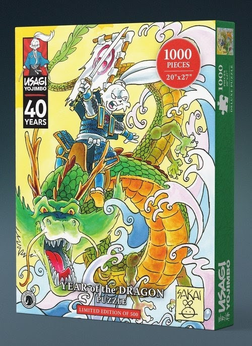 Auto-generated description: A vibrant 1000-piece jigsaw puzzle box features Usagi Yojimbo celebrating 40 years with an illustration of a samurai rabbit riding a fierce green dragon.