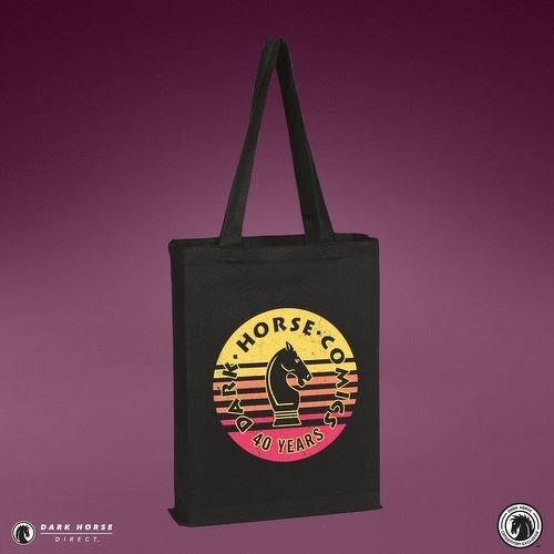 Auto-generated description: A black tote bag with a circular Dark Horse Comics 40 Years logo featuring a knight chess piece on a striped yellow and pink background.