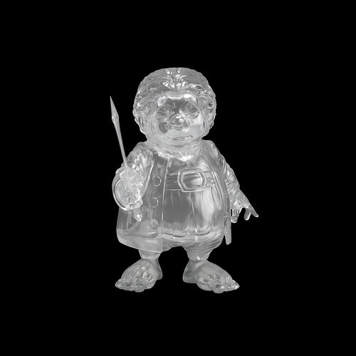 Auto-generated description: A translucent figurine of a hobbit holding a small spear is displayed against a black background.