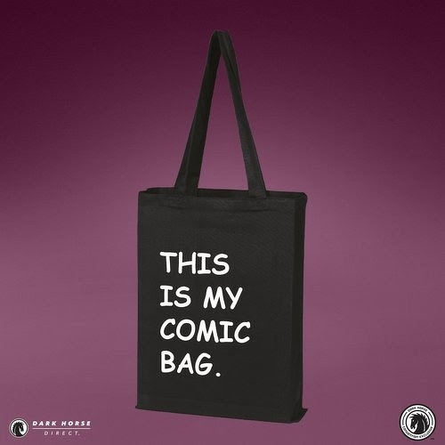 Auto-generated description: A black tote bag with the white text THIS IS MY COMIC BAG. printed on it is set against a purple background.