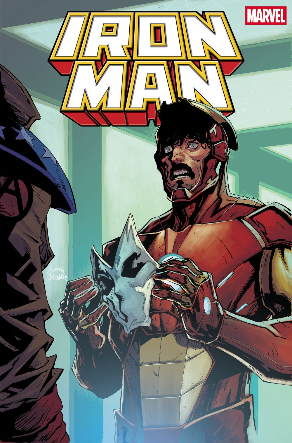 Auto-generated description: Iron Man is shown holding a wolf-like mask with a surprised expression, while another figure with a dark blue helmet and a white star on their shoulder is partially visible.
