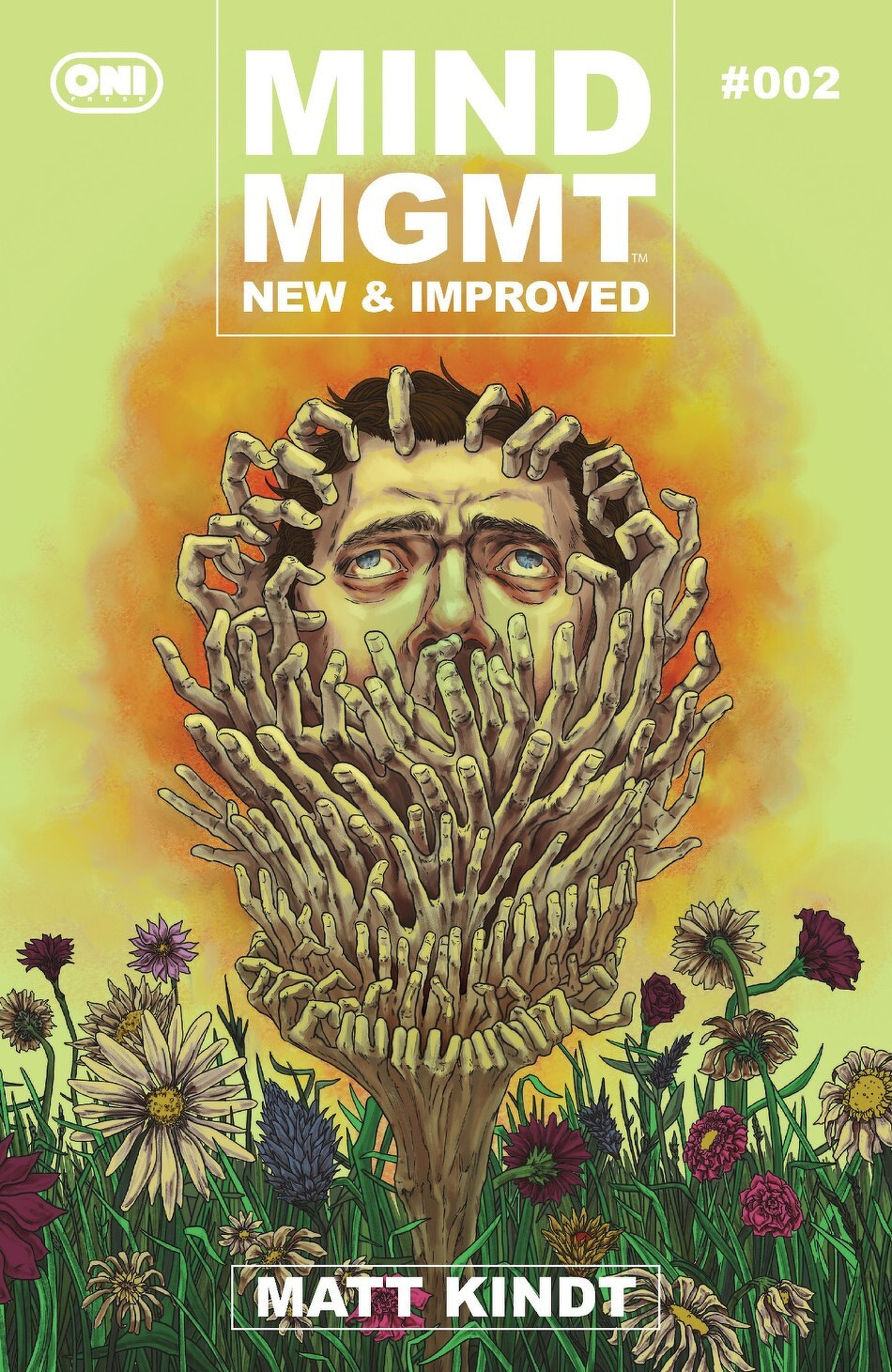 A man's face is surrounded by a wreath of hands against a surreal backdrop of flowers and a fiery sky, with the text Mind MGMT New & Improved #002 at the top.