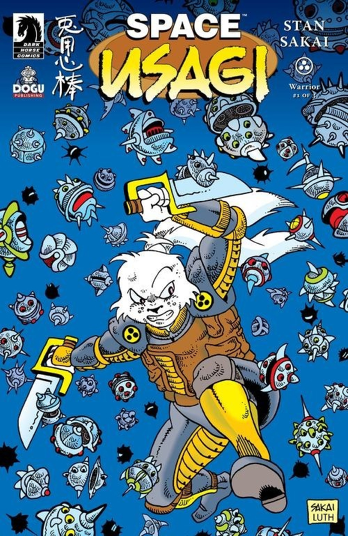 Auto-generated description: A fierce anthropomorphic rabbit warrior, armed with dual swords, battles an array of floating, spiked robotic enemies against a vivid blue background on the cover of Space Usagi comic book.