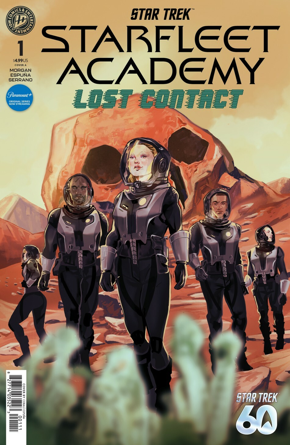 Auto-generated description: A group of five individuals in futuristic space suits explores a rocky, alien landscape with a skull-like formation in the background, on the cover of a Star Trek: Starfleet Academy - Lost Contact comic.