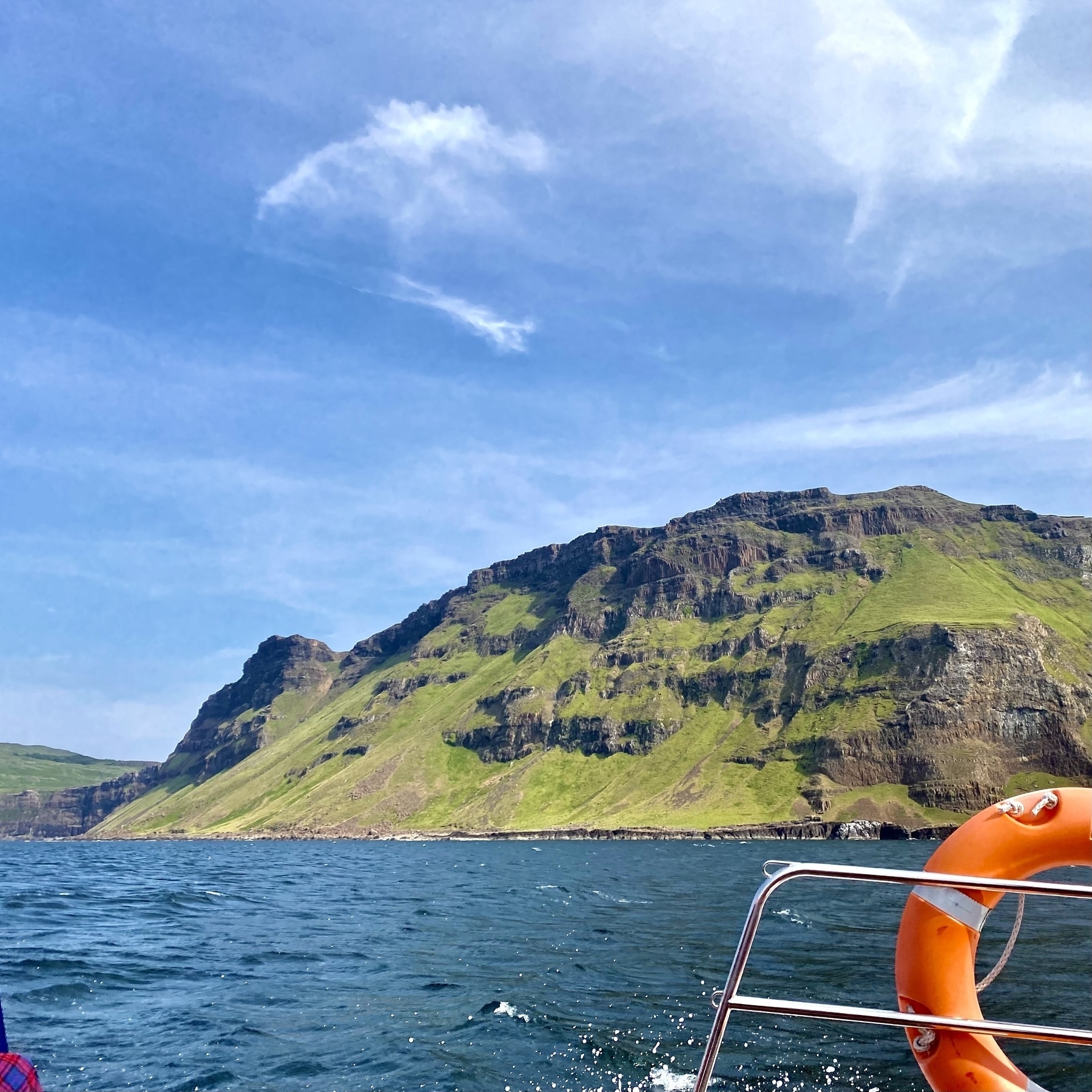 Photograph of the coastal cliffs of Mull taken from a small boat on a clear sunny day