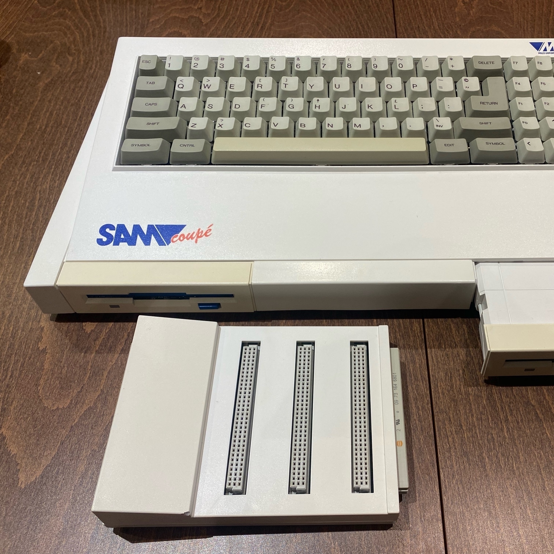 SAM Coupé computer with a SamCo card cage accessory. the floppy drive face plave on the SAM is noticeably more yellowed than the rest of the ostensibly white plastic