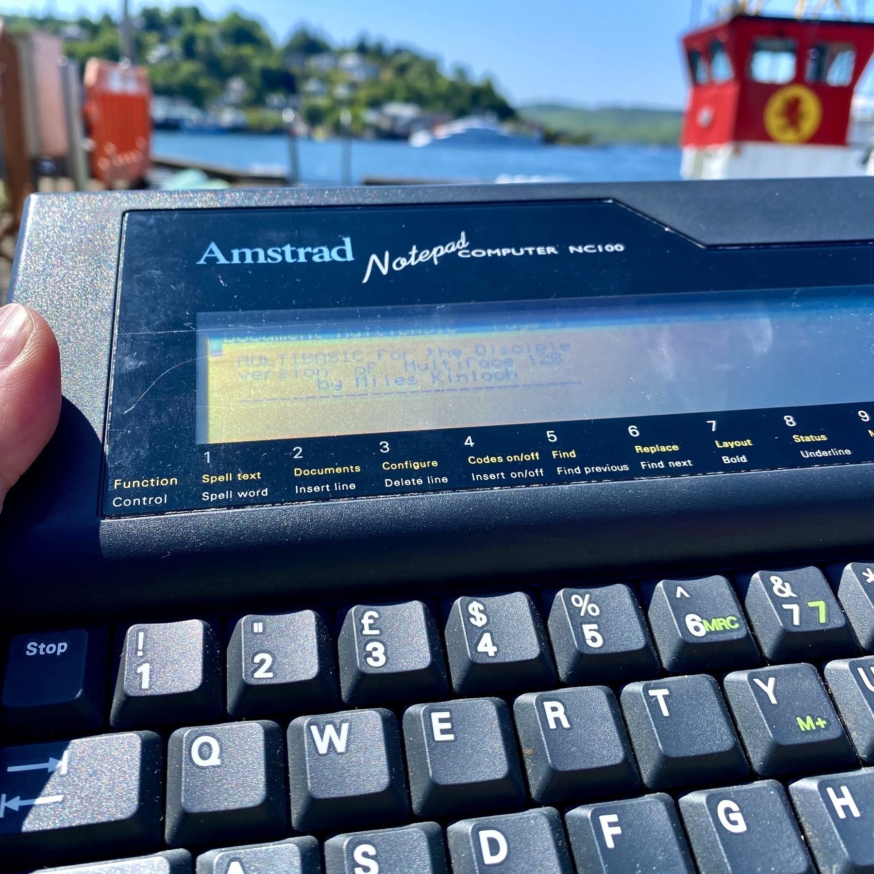 Photograph of Amstrad NC100 computer in the sunshine by the harbour