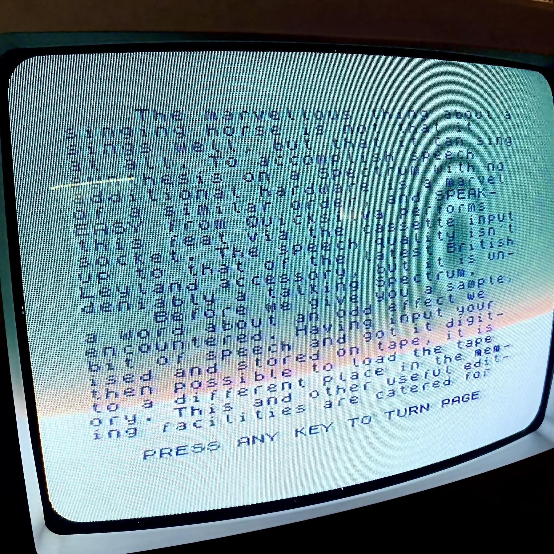 Screenshot of a CRT television set. Text on screen reads: The marvellous thing about a singing horse is not that it sings well but that it can sing at all. To accomplish speech synthesis on a Spectrum with no additional hardware is a marvel of a similar order.