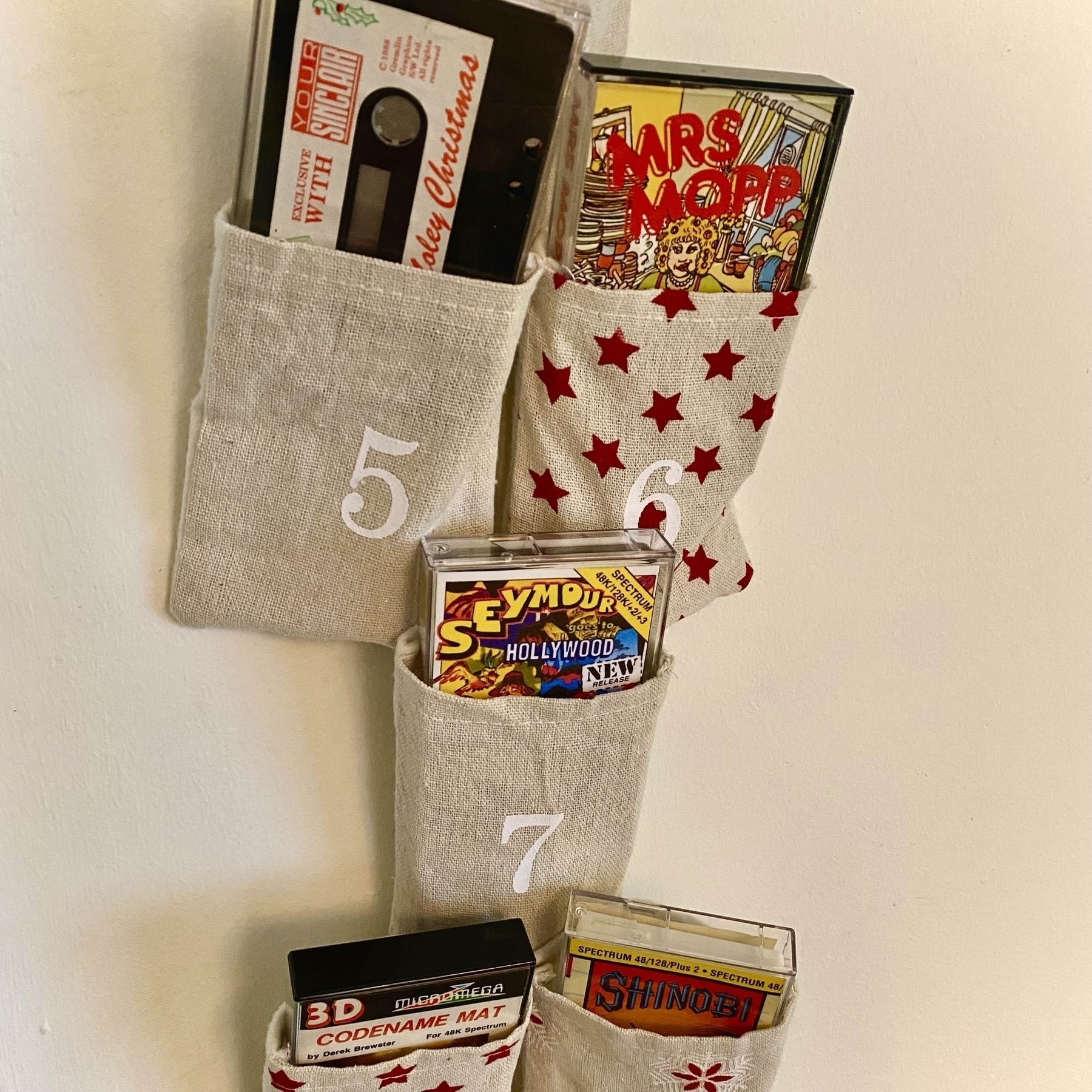 A wall-hanging advent calendar composed of several numbered canvas pockets that happen to be about the size of a standard boxed cassette tape. I’ve refilled the pockets with a selection of ZX Spectrum games including Moley Christmas, Mrs Mopp, Seymour goes to Hollywood, Codename Mat and Shinobi.