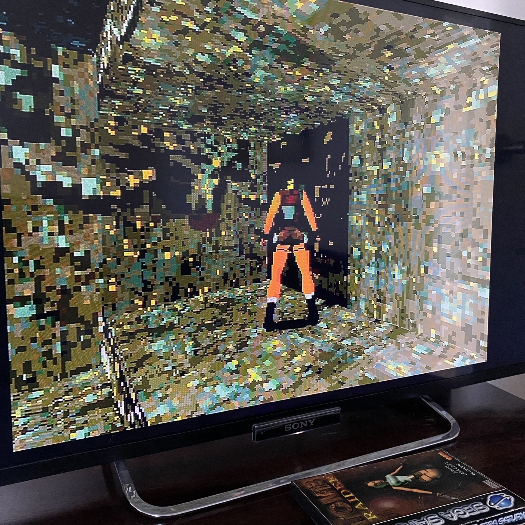 Screenshot of PAL version of Tomb Raider, the Cistern level. Lara Croft has moved the disguised moveable block but there’s a wall behind it blocking access to the secret area.