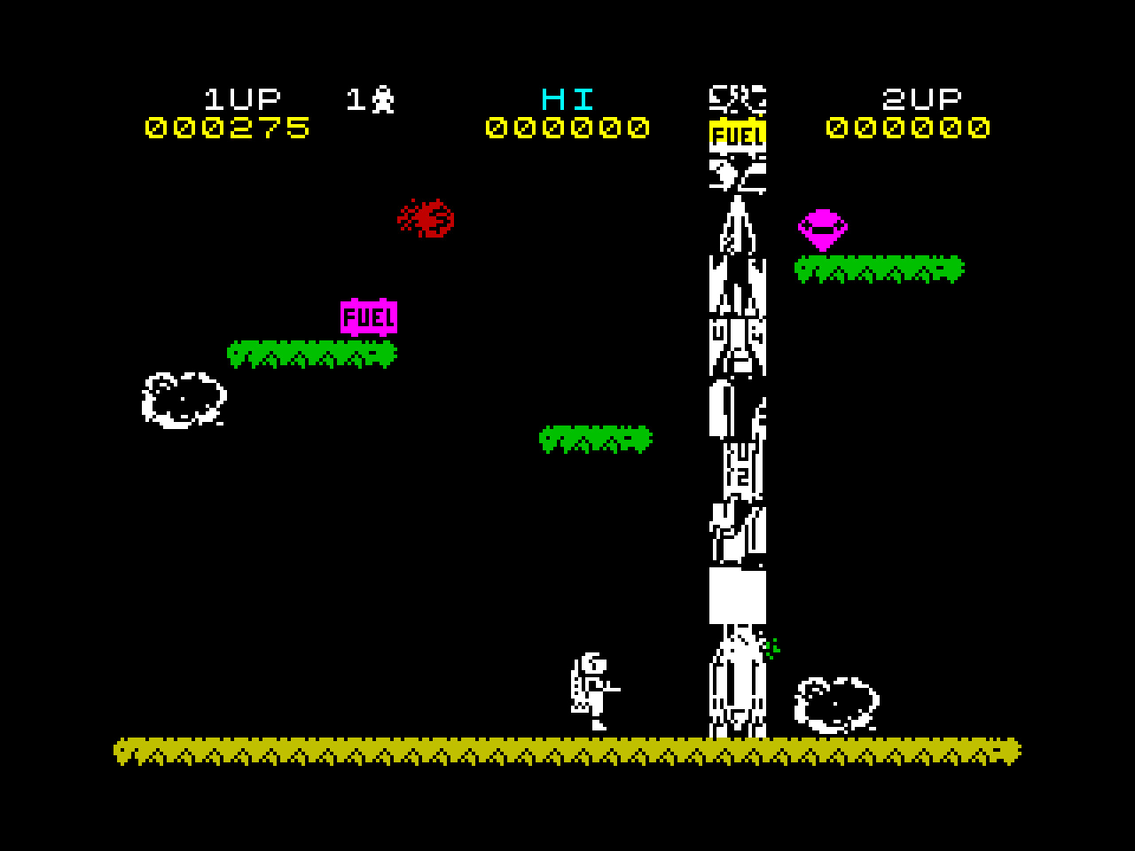 A screenshot from Jetpac on the ZX Spectrum. The rocket ship graphics have corrupted and it has turned into an improbable tower of jumbled spaceship parts.