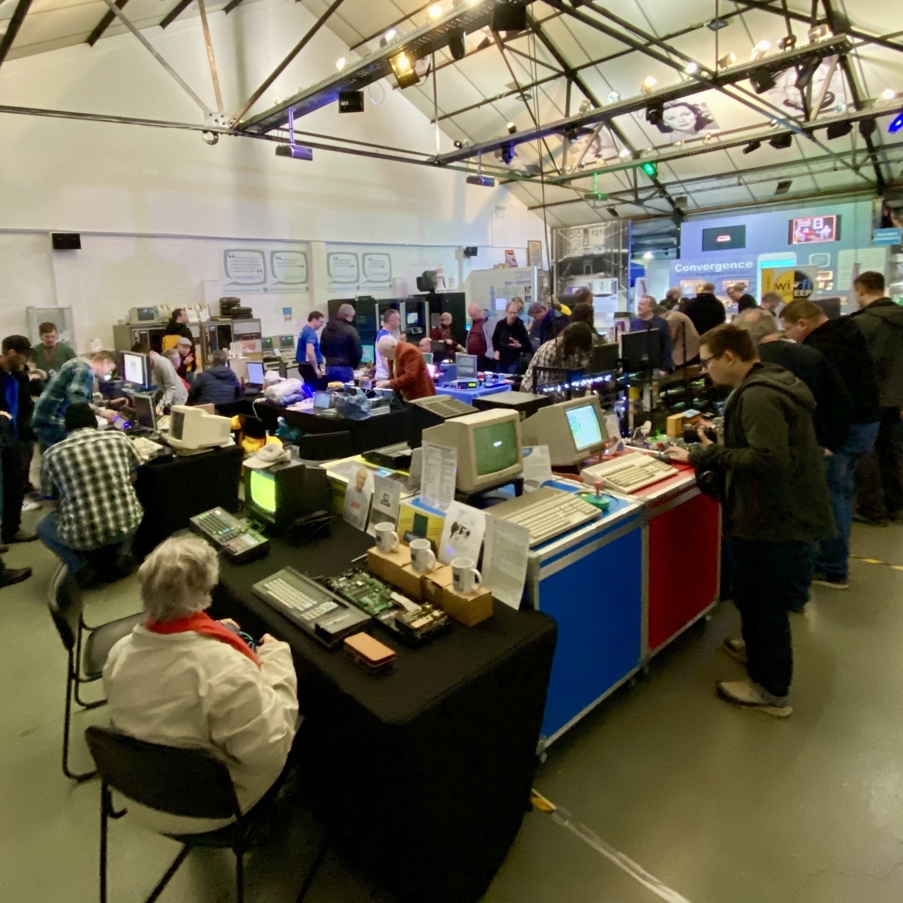 Main exhibition space at the Centre for Computing History. The room is filled with tables laden with vintage computing equipment.