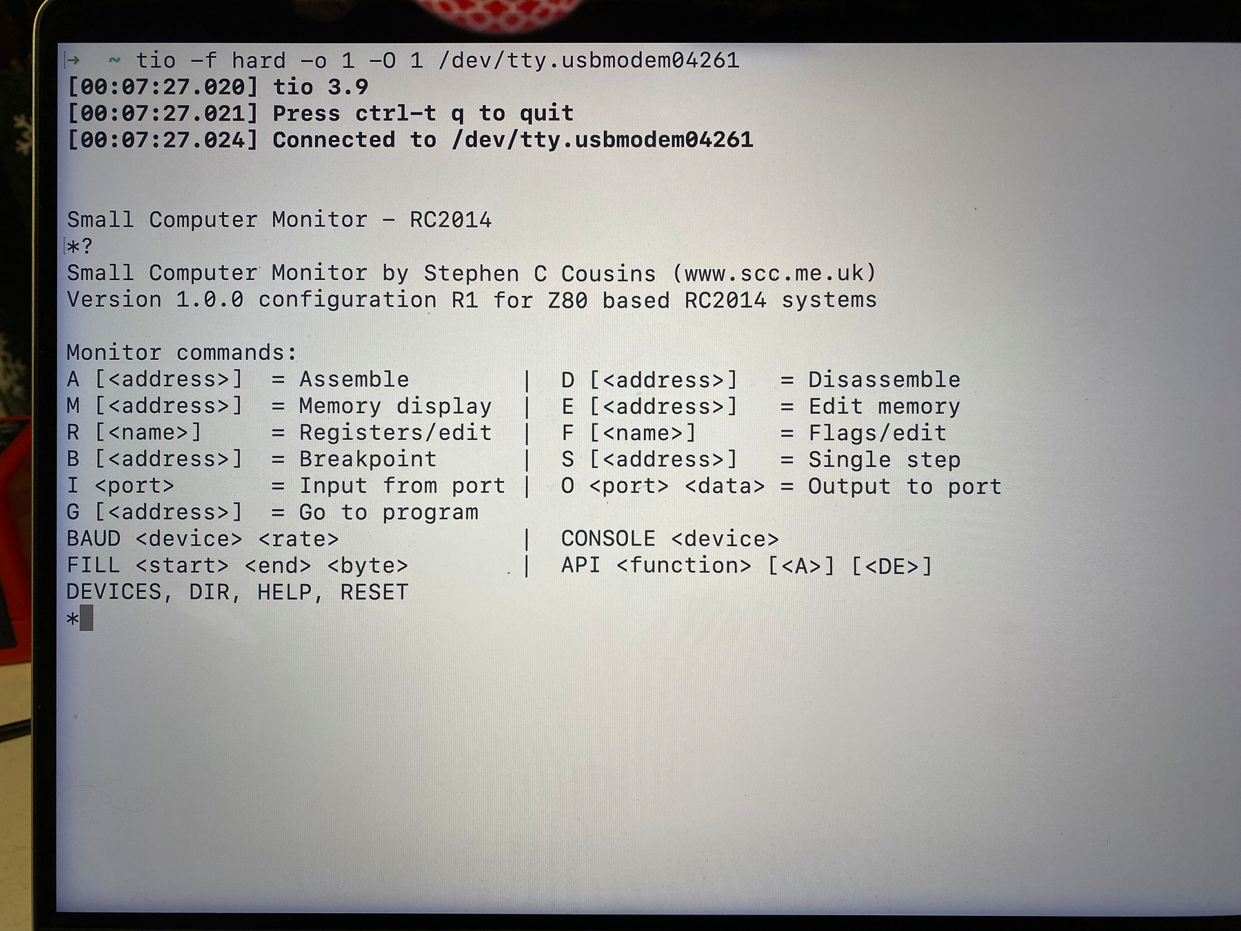 Another picture of a laptop screen showing a text terminal, this time showing Stephen C Cousins’ “Small Computer Monitor” running on SAM and connected over USB serial. Text on screen is a listing of the SCM commands.