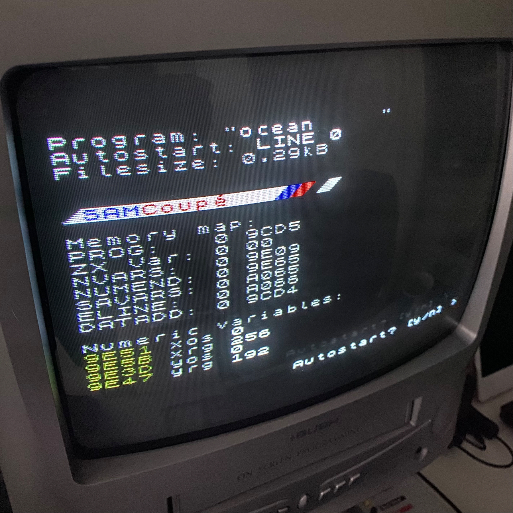 Photo of a TV screen, text describes a BASIC program called “ocean” being loaded.