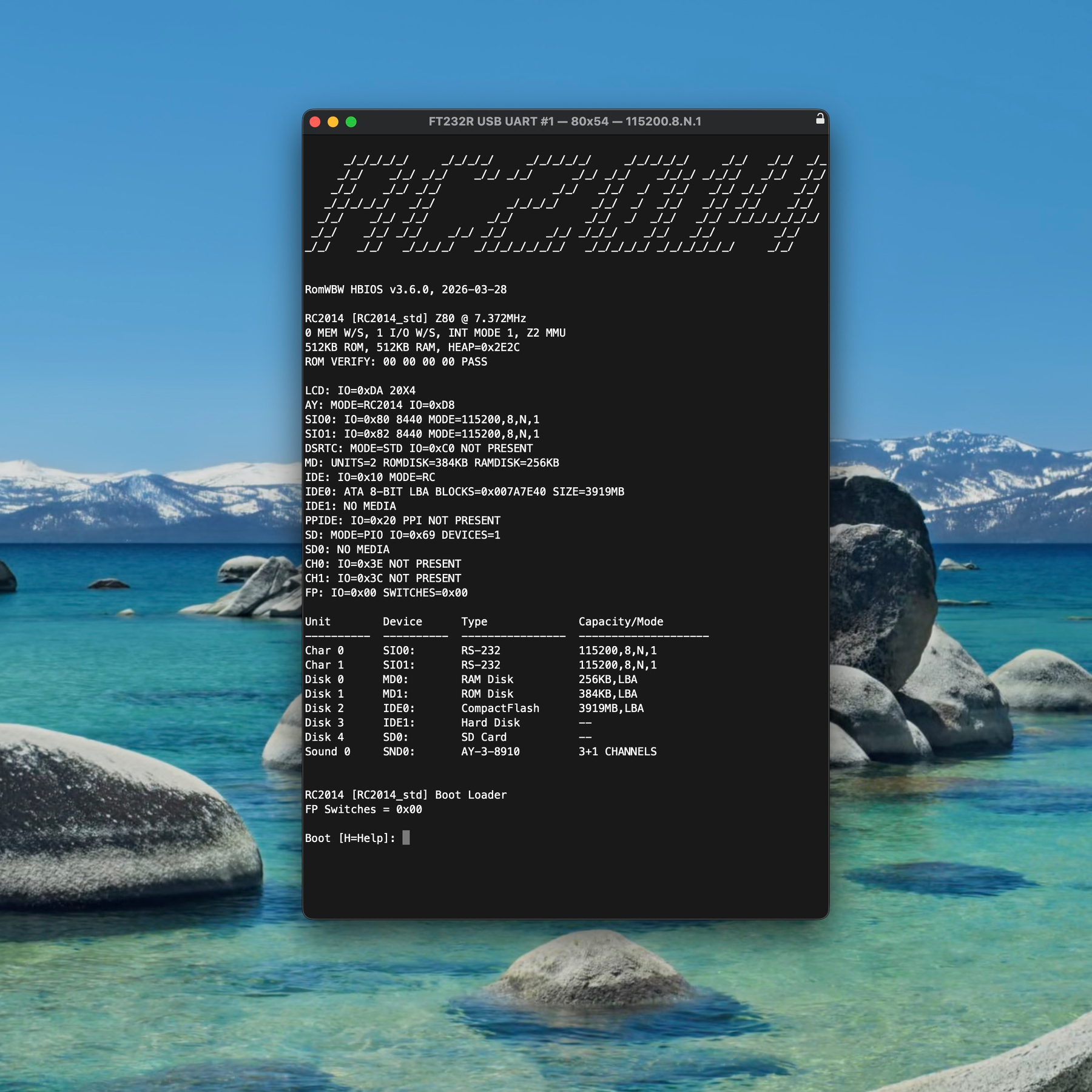 A desktop computer screenshot showing a white-on-black terminal emulator application. The text shown in the terminal window is the boot message generated by RC2014 RomWBW. It is headed by an ASCII-art RC2014 logo, and a comprehensive dump of system information indicating the attached media and so on. The text ends with the prompt: Boot [H=help]