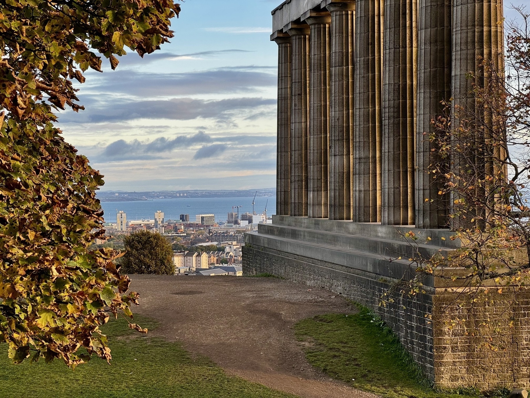 View from Calton Hill, Edinburgh, with the National Monument, foreground right, with the sea in the distance