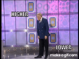 Bruce Forsyth stands between two playing cards on the Play Your Cards Right set, HIGHER on the left and LOWER on the right