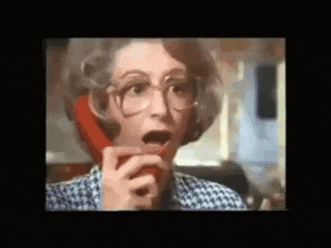 Auto-generated description: A surprised woman is talking on a red telephone with her mouth open.