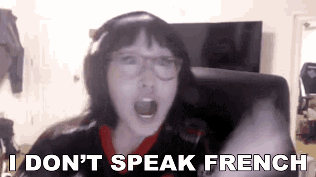 Auto-generated description: A person with glasses and headphones is animatedly exclaiming, I DON'T SPEAK FRENCH.