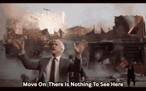 Auto-generated description: Leslie Nielsen gestures for people to move on amid chaos and destruction, with subtitles reading Move On There Is Nothing To See Here.