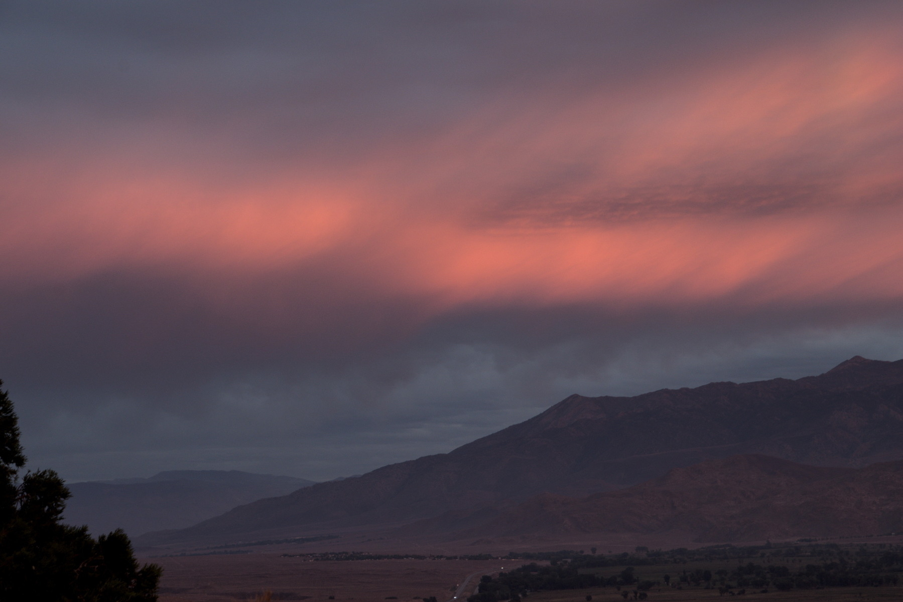 Pink cloud bank at sunset over trailing edge of the Sierra Nevada