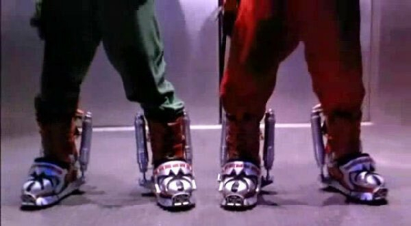 Two people are wearing futuristic-looking boots with metallic and patterned designs, standing side by side. Screenshot from Super Mario Bros the film