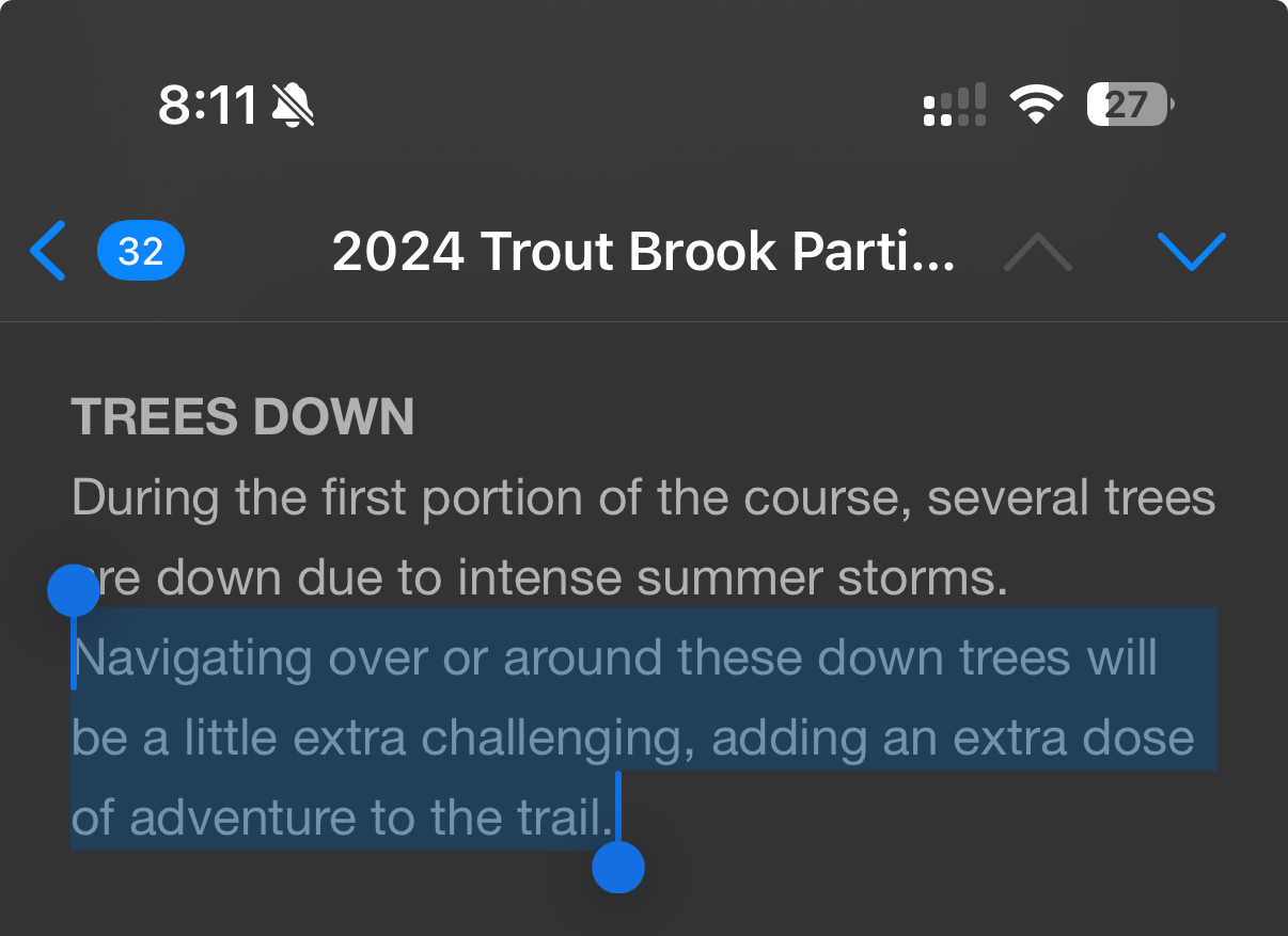 Text on a dark screen announces: “2024 Trout Brook Partici…” focusing on “Trees Down.” Several trees on the course are down due to storms, making navigation challenging and adding adventure.