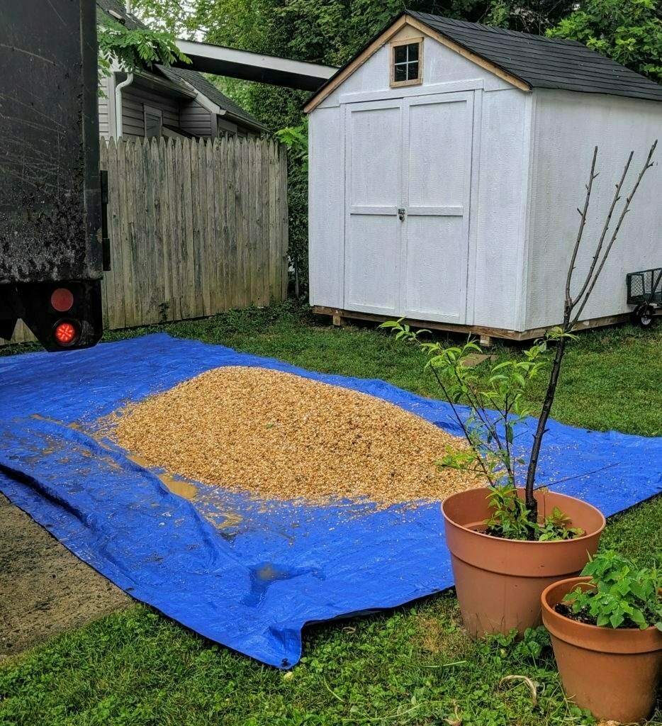 One ton of pea gravel on a blue tarp.