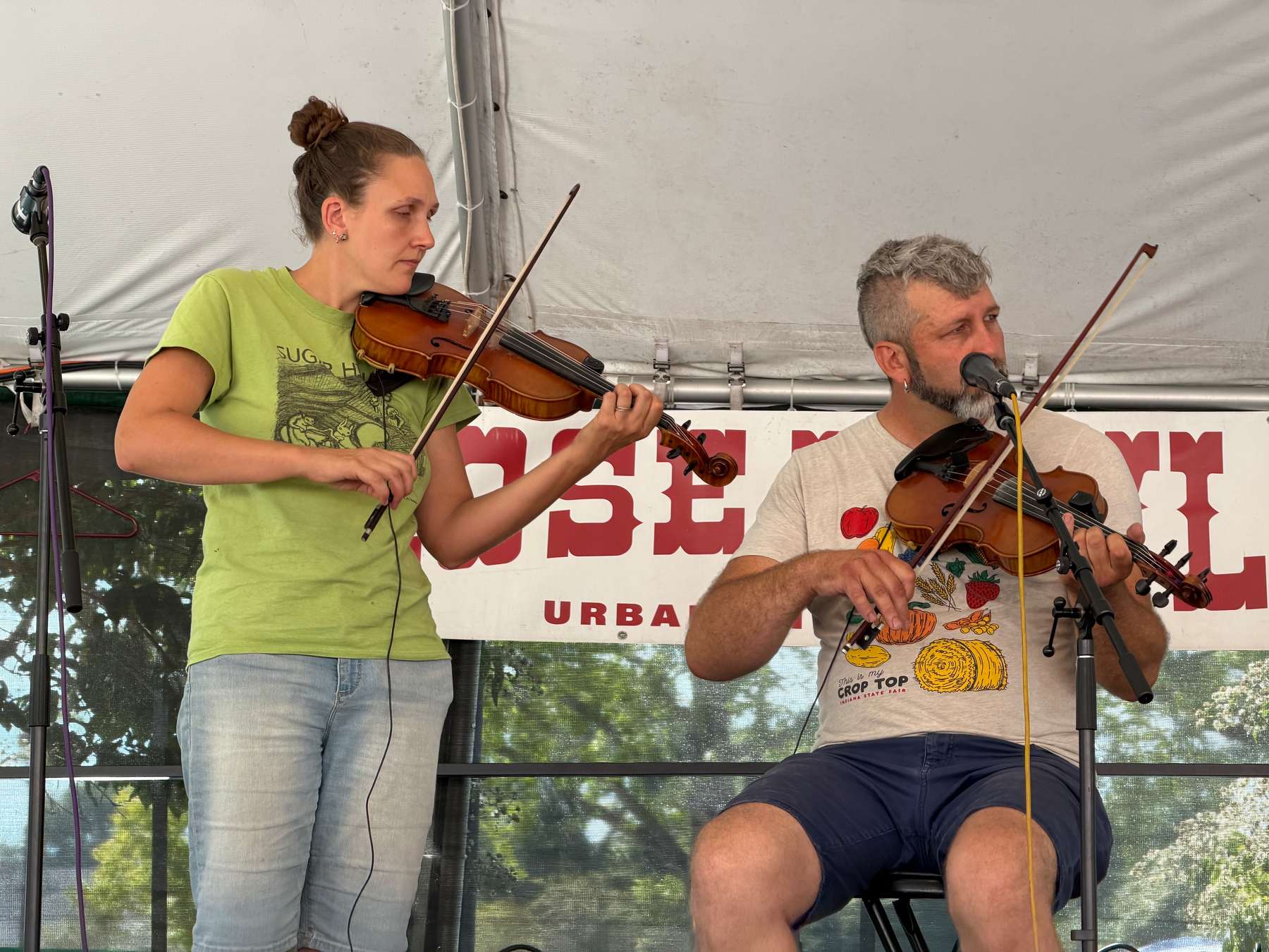 photo of two fiddlers playing on stage