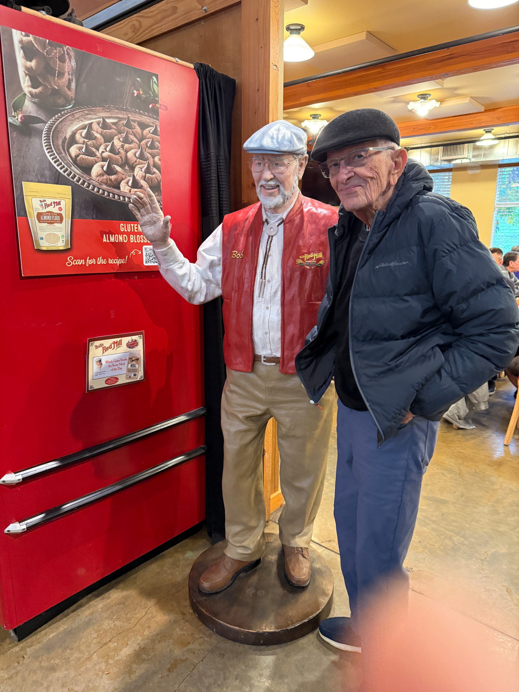 My father in a cap with a similar looking statue of the founder of Bob’s Red Mill. 