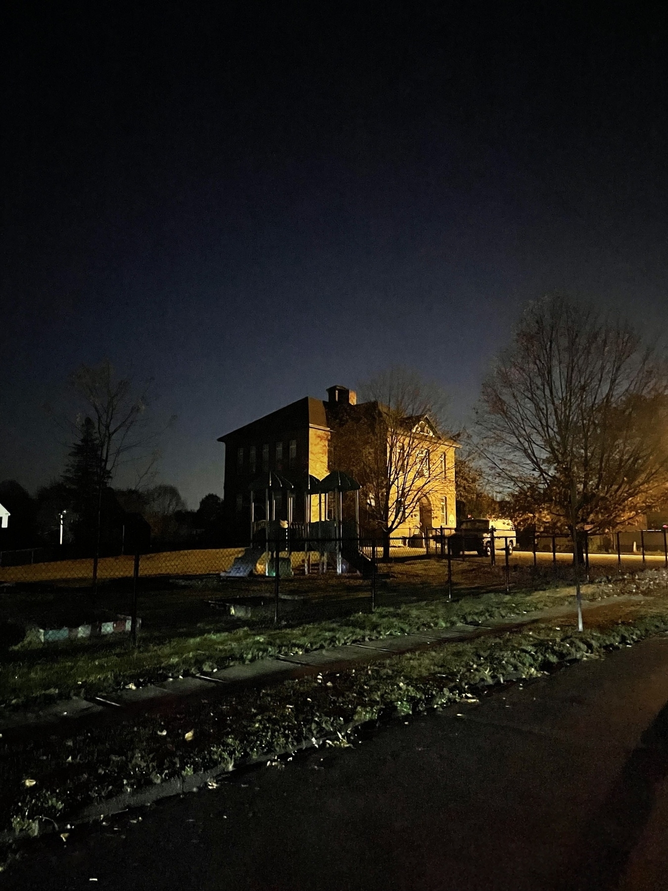 Brick building with playground, just before dawn