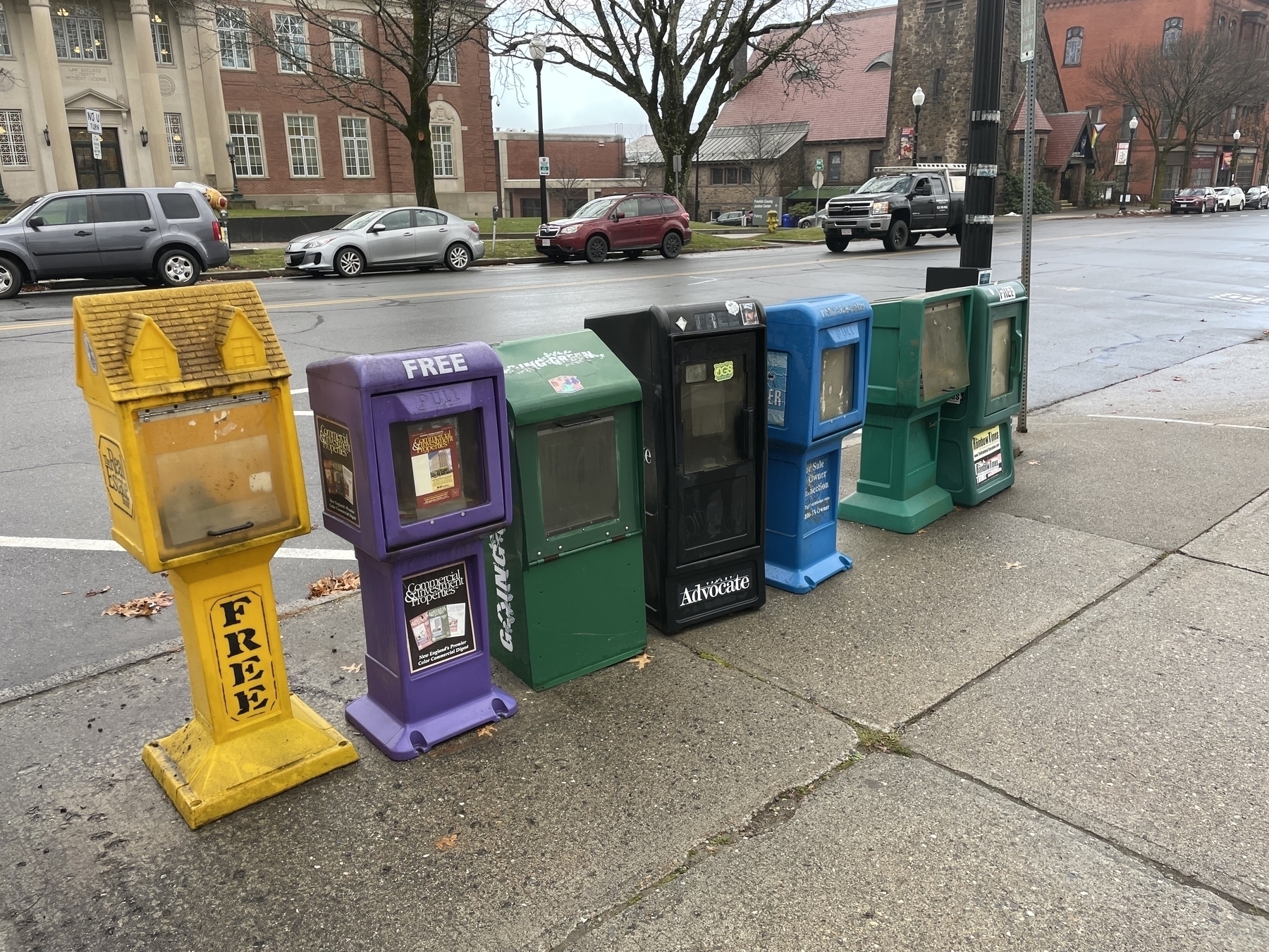 Seven empty newspaper bins on Main Street - Greenfield, MA