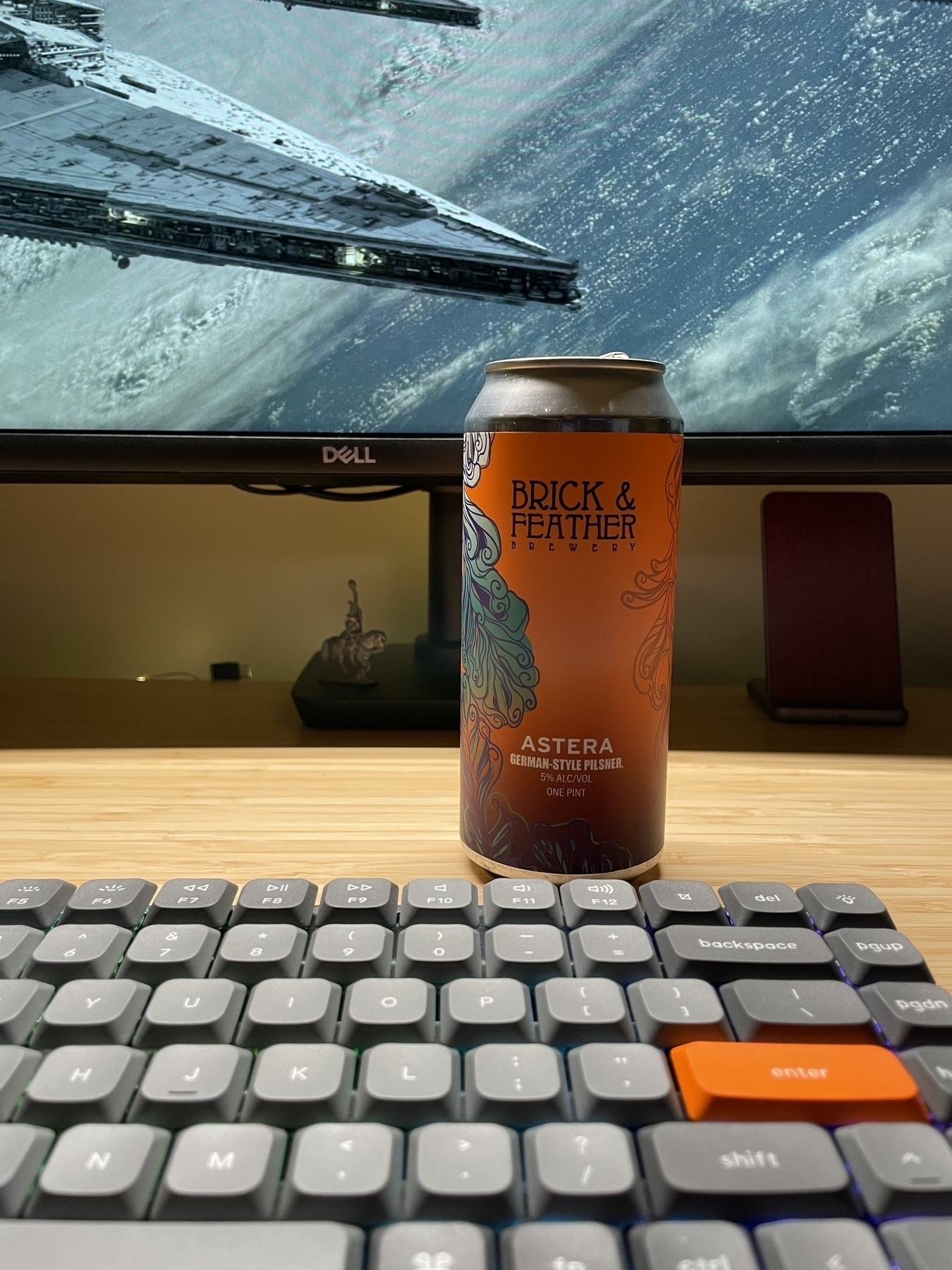 Can of beer between keyboard and monitor
