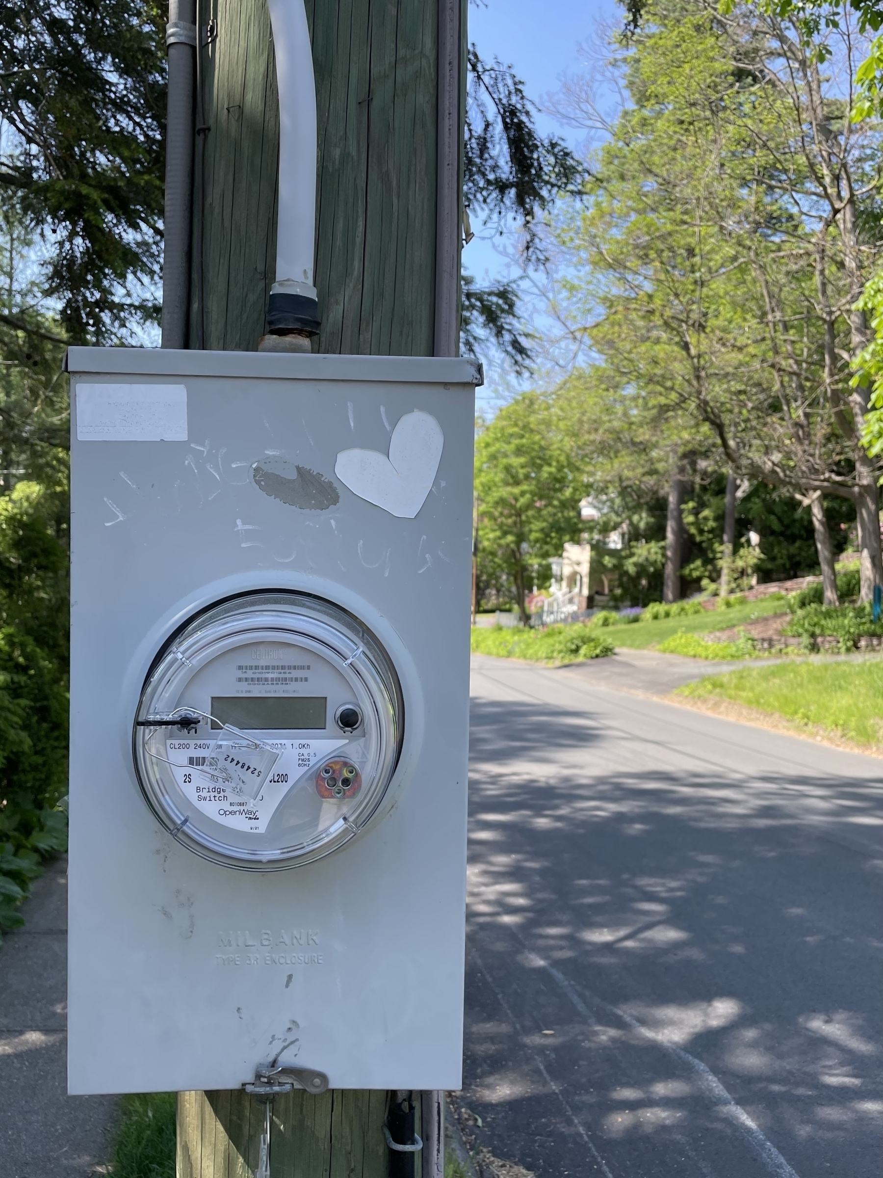 Electric meter with heart sticker on a utility pole