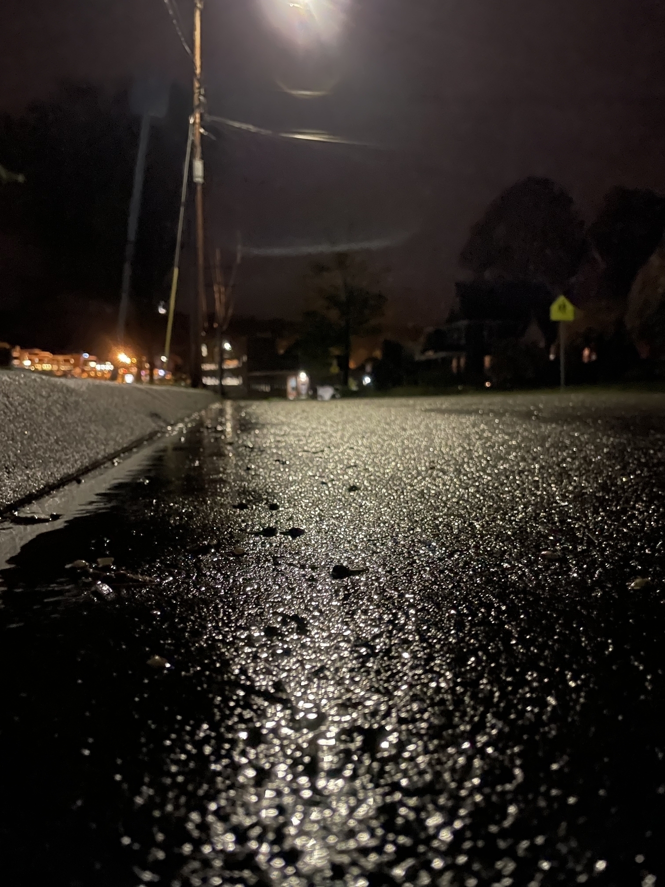 Wet pavement on Sanderson St. at night