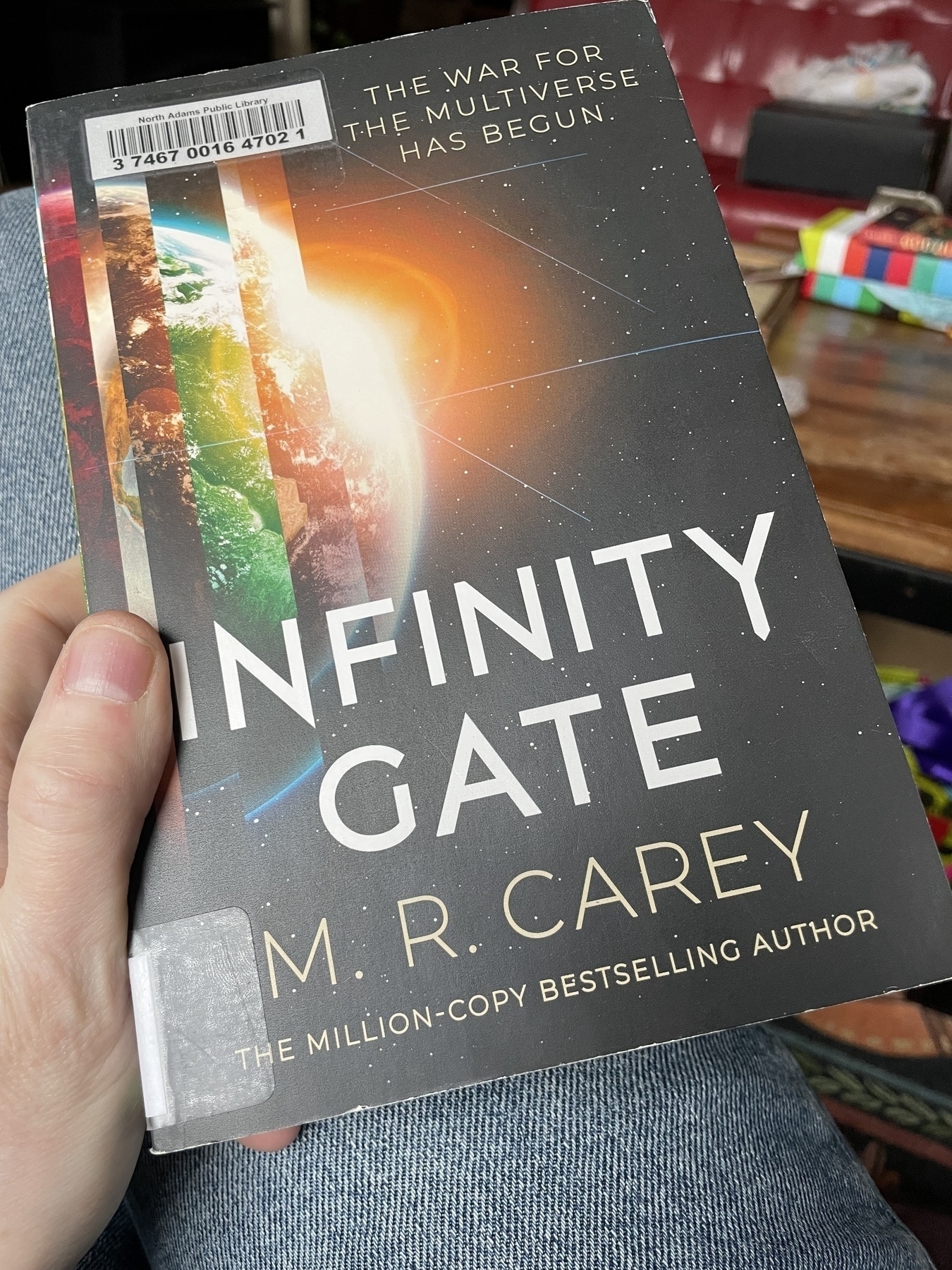 A physical copy of the book Infinity Gate by M.R. Carey