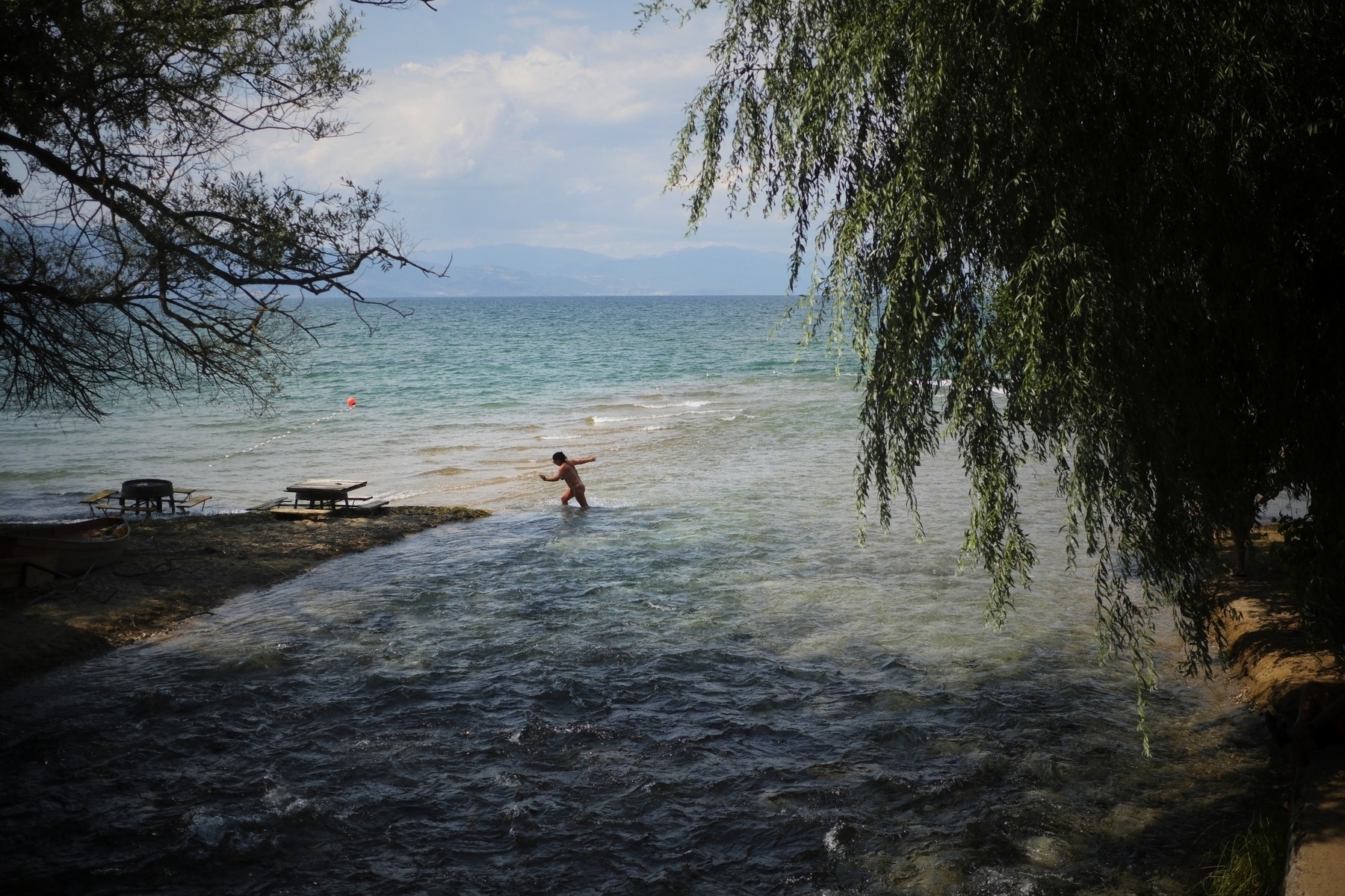 Beach goers by the waterfront in Pogradec 