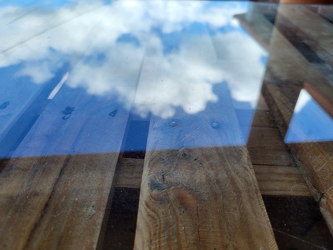 Clouds reflection on glass table 