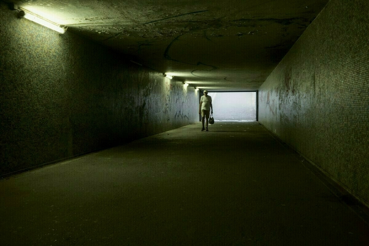 Man walking in tunnel